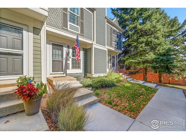 a view of a house with potted plants