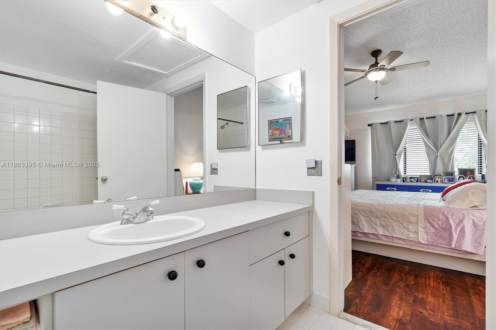 4347 Southwest 70th Terrace Davie, FL 33314 - Photo 15 of 32 a en suite bathroom with a double vanity sink a mirror and a shower