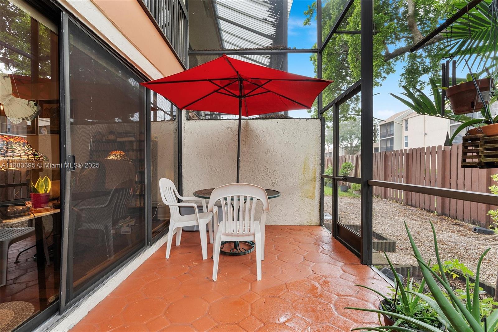4347 Southwest 70th Terrace Davie, FL 33314 - Photo 20 of 32 a view of a patio with a table chairs and a fire pit