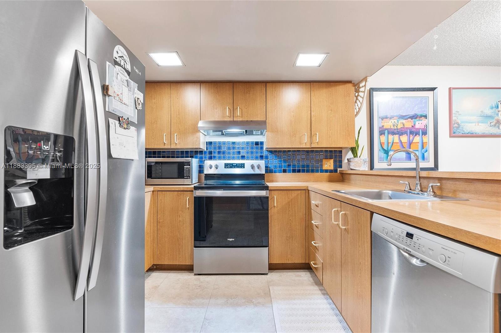 4347 Southwest 70th Terrace Davie, FL 33314 - Photo 2 of 32 a kitchen with stainless steel appliances a stove sink and cabinets