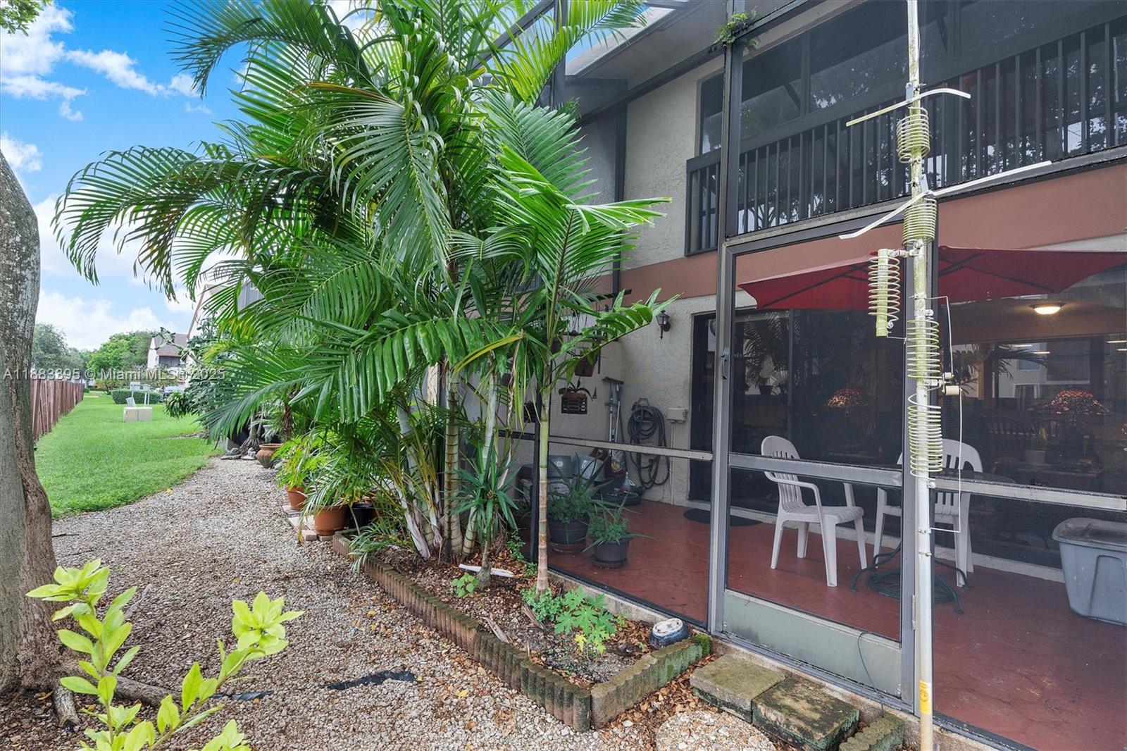 4347 Southwest 70th Terrace Davie, FL 33314 - Photo 22 of 32 a backyard of a house with lots of green space and fountain