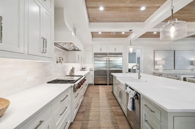 a kitchen with stainless steel appliances a sink and stove