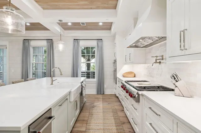 a kitchen with stainless steel appliances granite countertop a sink a stove and a refrigerator