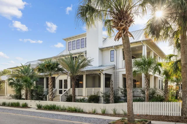 a front view of a house with a tree