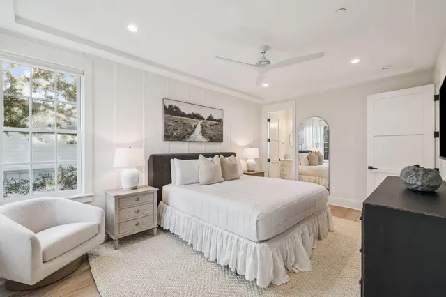 a living room with furniture a flat screen tv and kitchen view