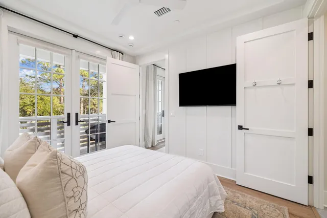 a view of a white house with a swimming pool and a chairs