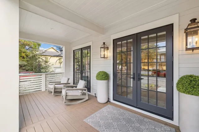a living room with furniture and large windows