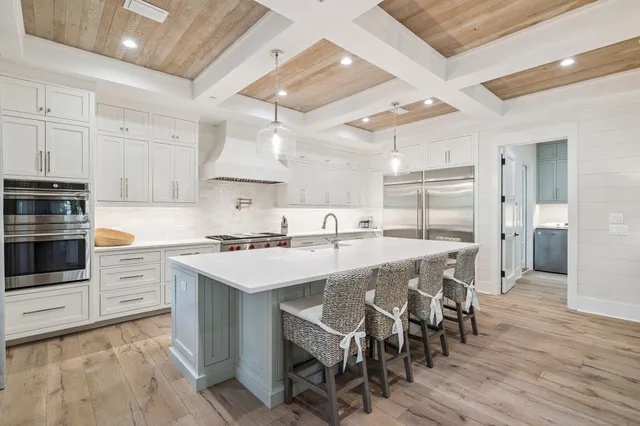 a kitchen with a table chairs stove and cabinets
