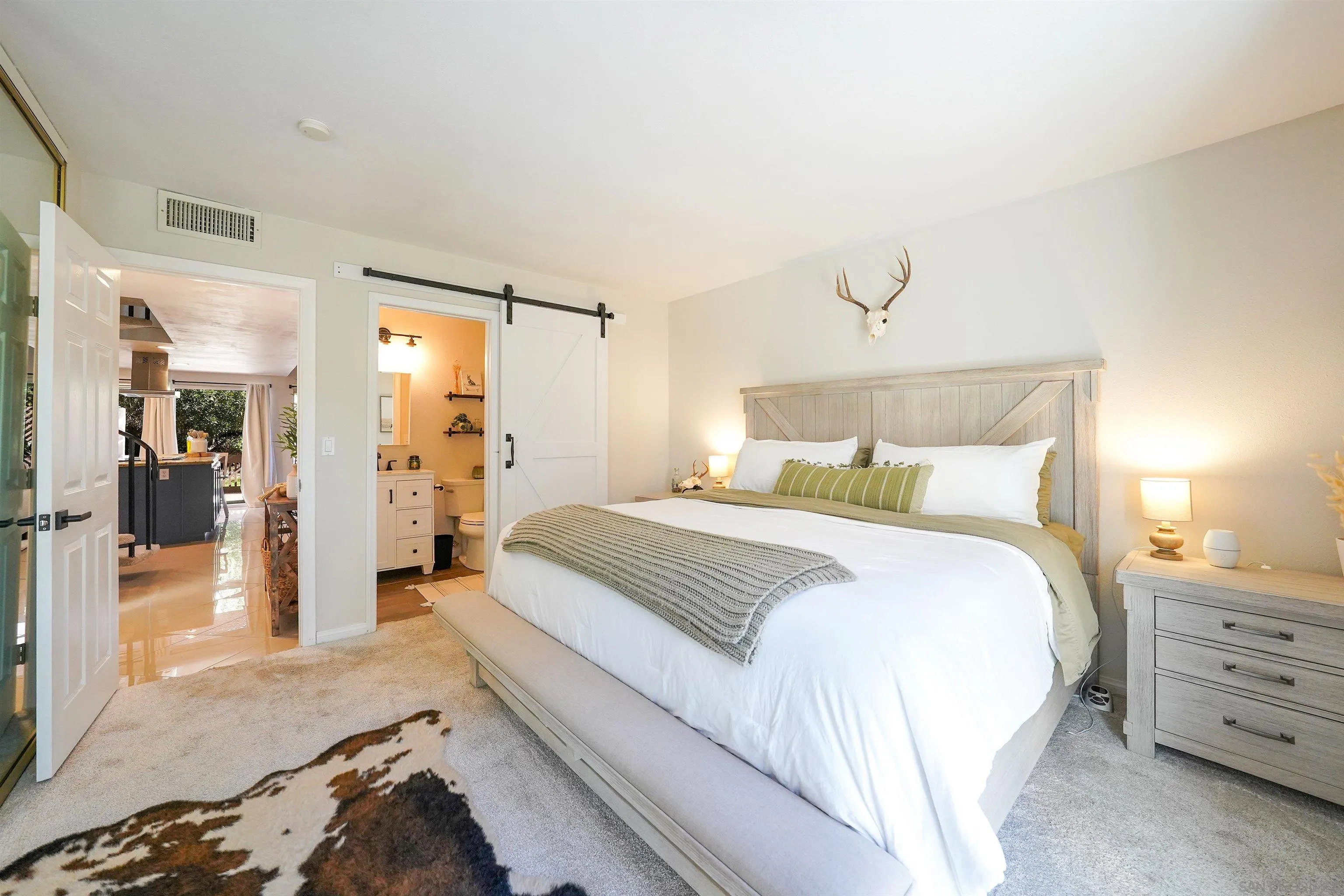 23658 Country Villa Road Ramona, CA 92065 - Photo 11 of 29 a bedroom with a bed and a walk in closet
