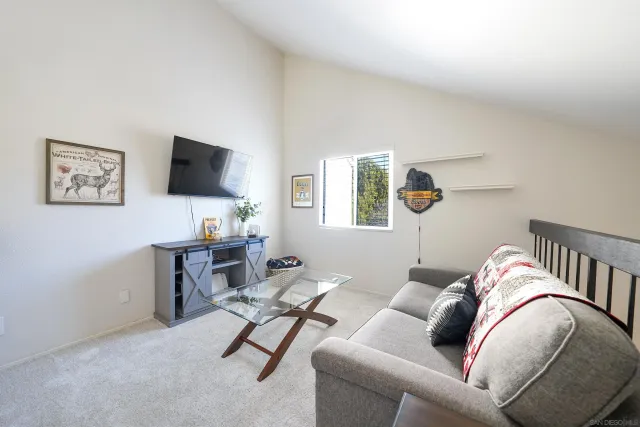 a view of a livingroom with workspace and a couch