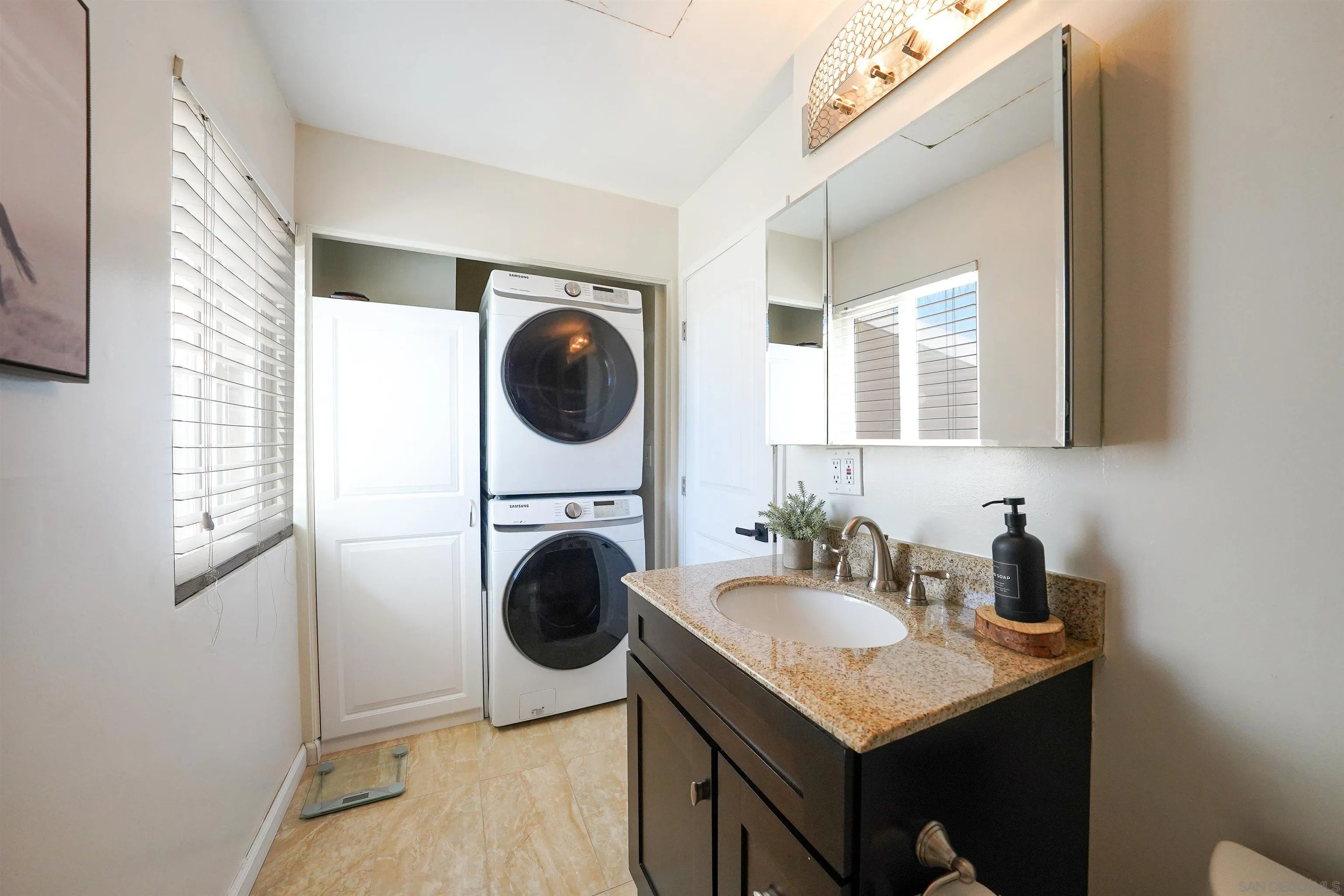 23658 Country Villa Road Ramona, CA 92065 - Photo 19 of 29 a kitchen with a sink a washer and dryer