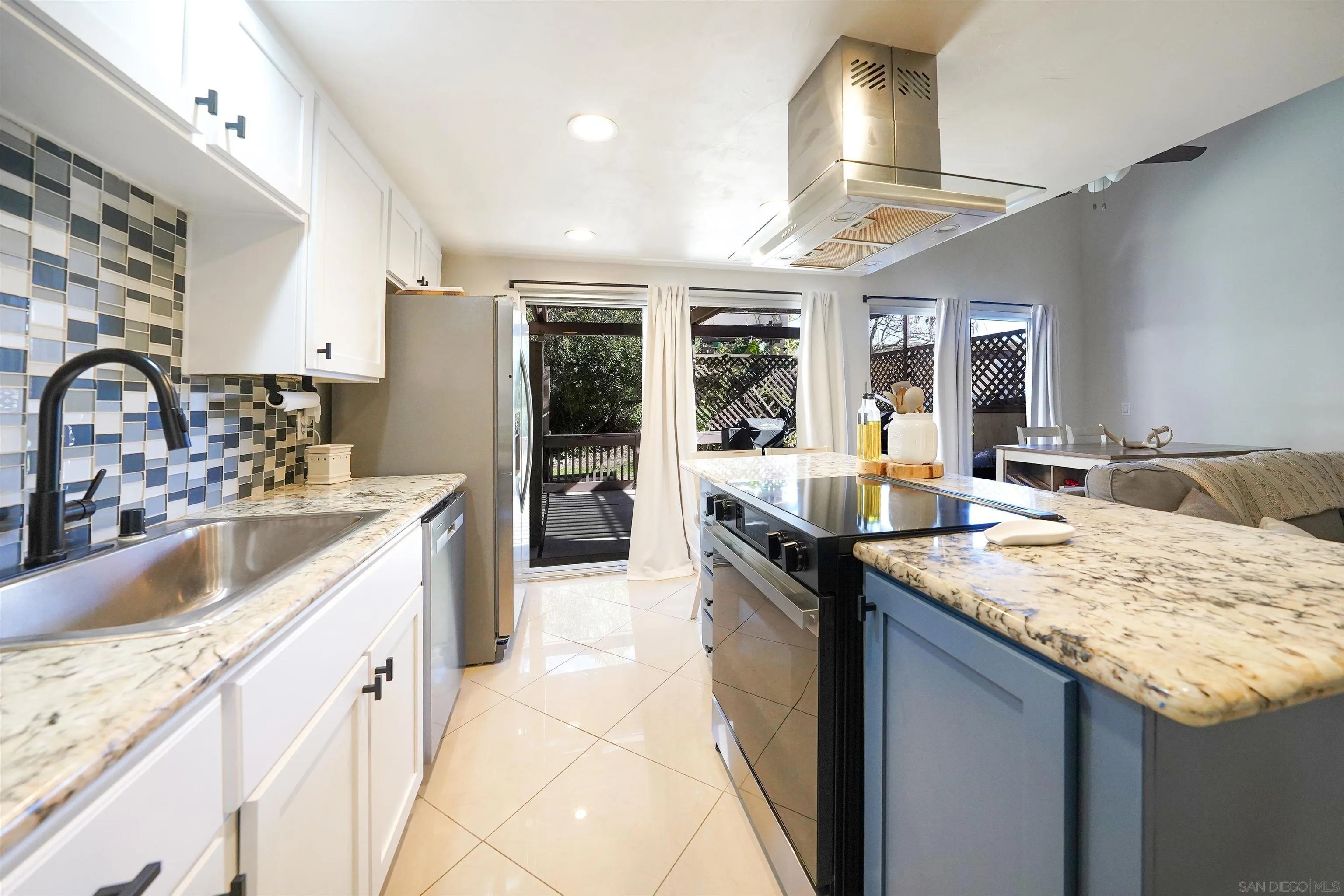 23658 Country Villa Road Ramona, CA 92065 - Photo 5 of 29 a kitchen with granite countertop a sink stove and cabinets