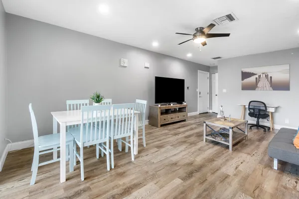 a living room with furniture and a wooden floor