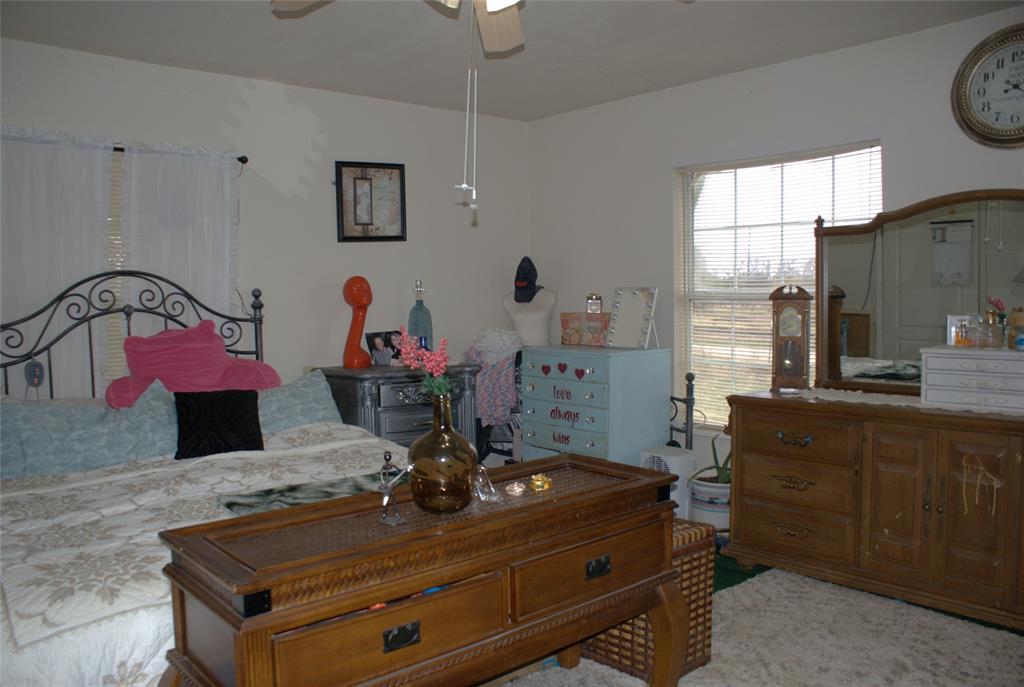 8660 County Road 308 Terrell, TX 75161 - Photo 11 of 18 a room with kitchen island stainless steel appliances furniture a sink and a window