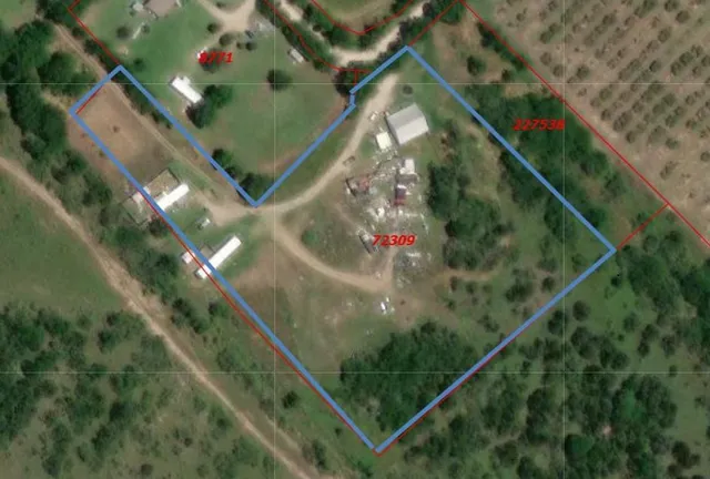 a view of outdoor space with green field and trees