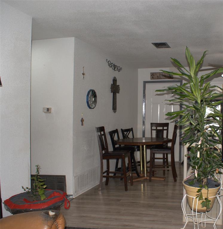 8660 County Road 308 Terrell, TX 75161 - Photo 9 of 18 a view of a dining room with furniture and wooden floor