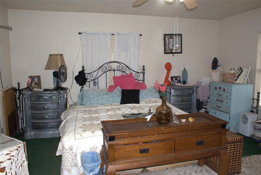 8660 County Road 308 Terrell, TX 75161 - Photo 10 of 18 a bed room with a bed and a dresser