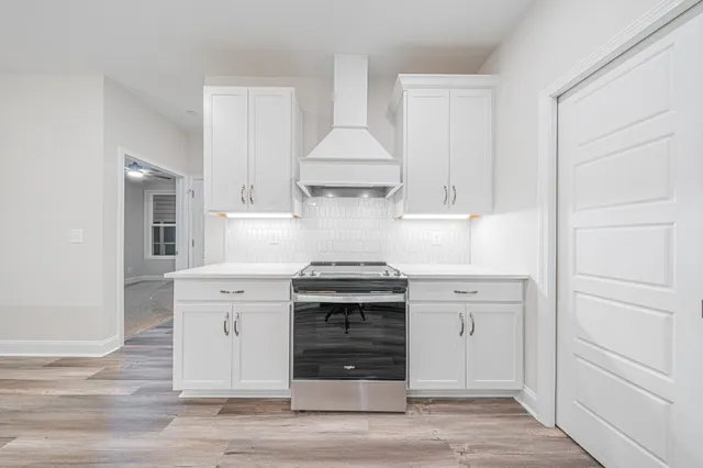 a kitchen with a stove and cabinets
