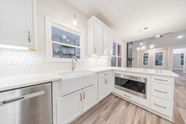 a large white kitchen with a large window