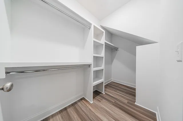 a view of walk in closet with empty racks