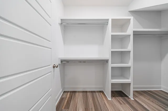 an empty room with a ceiling fan and a window