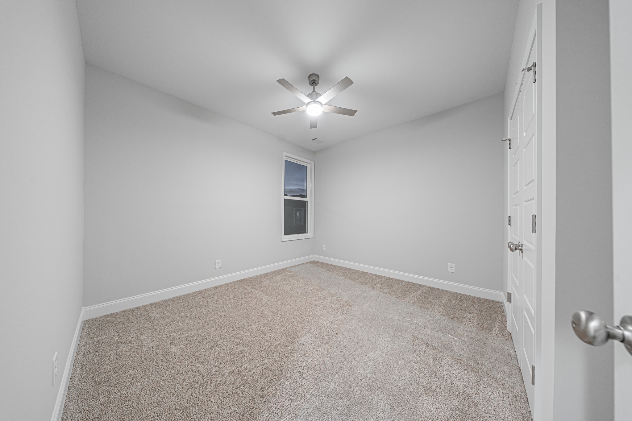 110 Gower Street Pleasant View, TN 37146 - Photo 24 of 32 an empty room with a ceiling fan and a window