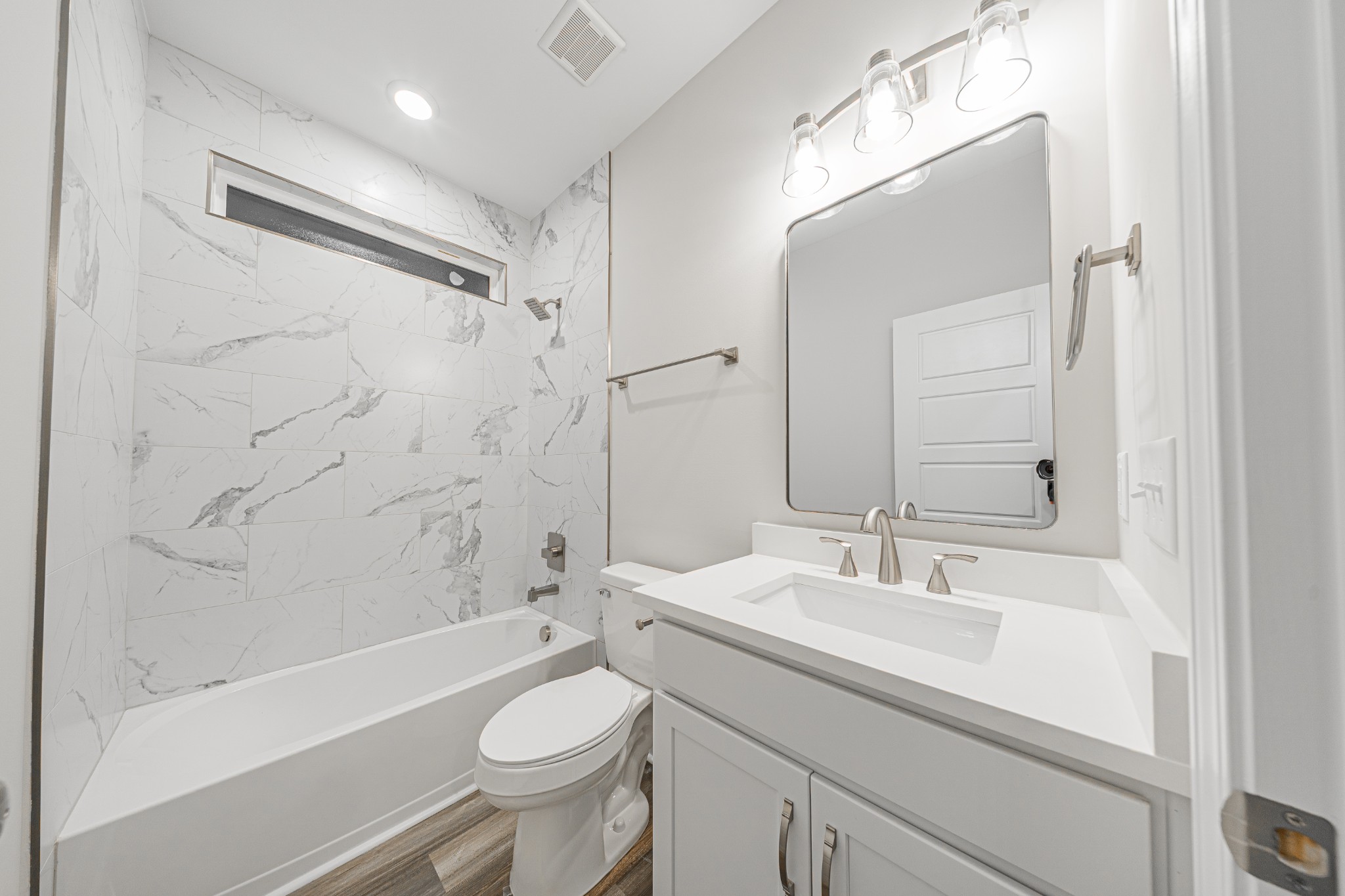 110 Gower Street Pleasant View, TN 37146 - Photo 27 of 32 a bathroom with a sink a toilet a mirror a bathtub and shower