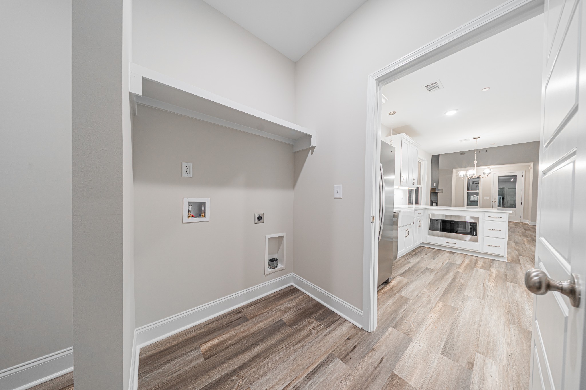 110 Gower Street Pleasant View, TN 37146 - Photo 32 of 32 a view of a hallway with wooden floor and a living room