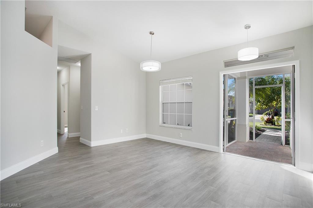 2921 Inlet Cove Lane East Naples, FL 34120 - Photo 11 of 48 an empty room with wooden floor and windows