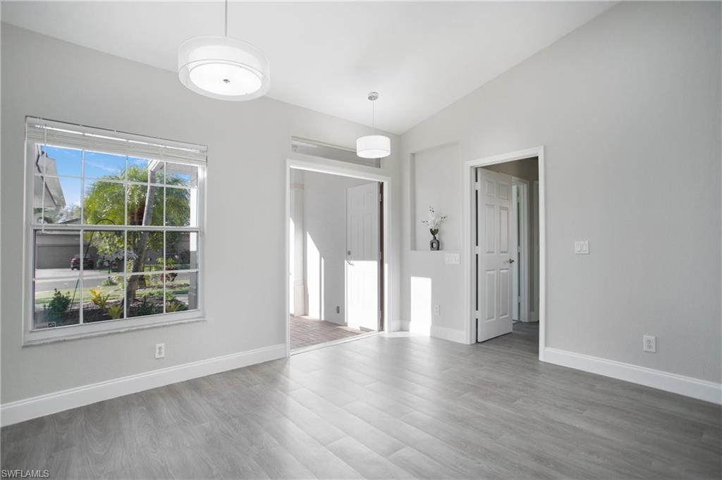 2921 Inlet Cove Lane East Naples, FL 34120 - Photo 12 of 48 an empty room with wooden floor and windows