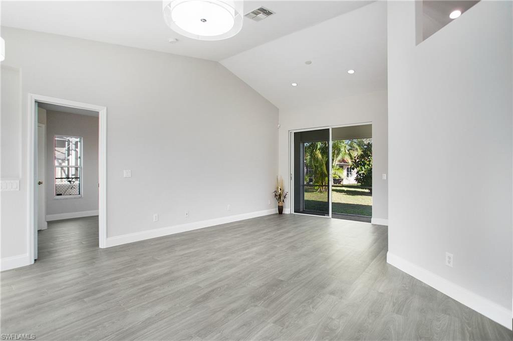 2921 Inlet Cove Lane East Naples, FL 34120 - Photo 14 of 48 wooden floor in an empty room with a window