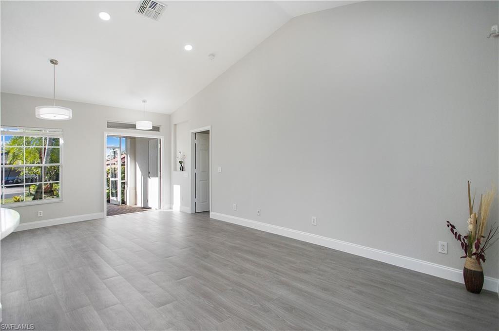 2921 Inlet Cove Lane East Naples, FL 34120 - Photo 15 of 48 a view of an empty room with wooden floor and a window