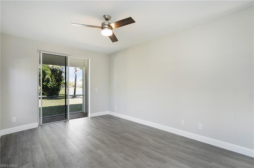 2921 Inlet Cove Lane East Naples, FL 34120 - Photo 17 of 48 an empty room with wooden floor and windows