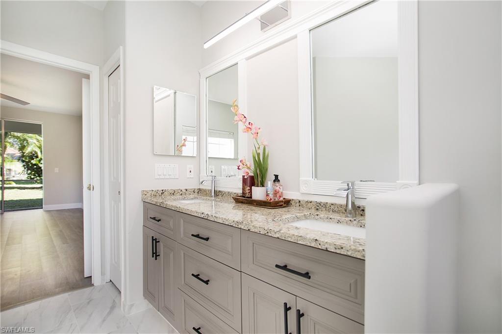 2921 Inlet Cove Lane East Naples, FL 34120 - Photo 20 of 48 a bathroom with a granite countertop sink and a mirror
