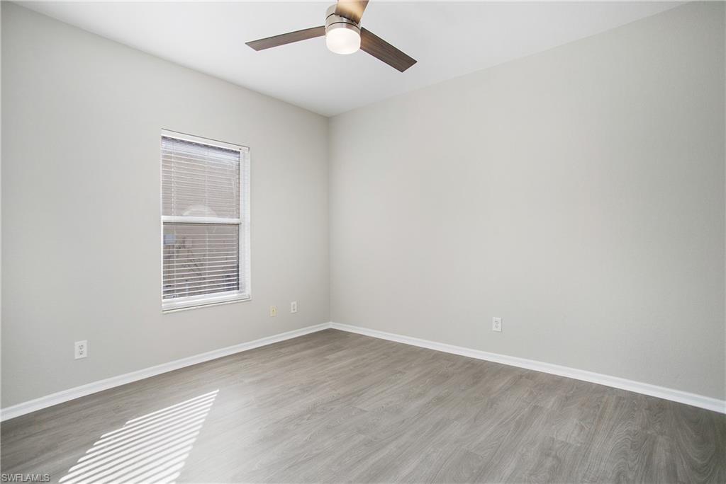 2921 Inlet Cove Lane East Naples, FL 34120 - Photo 23 of 48 an empty room with a window and ceiling fan