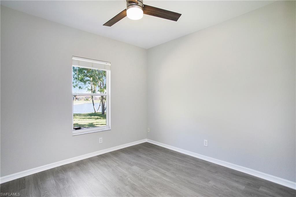 2921 Inlet Cove Lane East Naples, FL 34120 - Photo 24 of 48 an empty room with a window and a ceiling fan