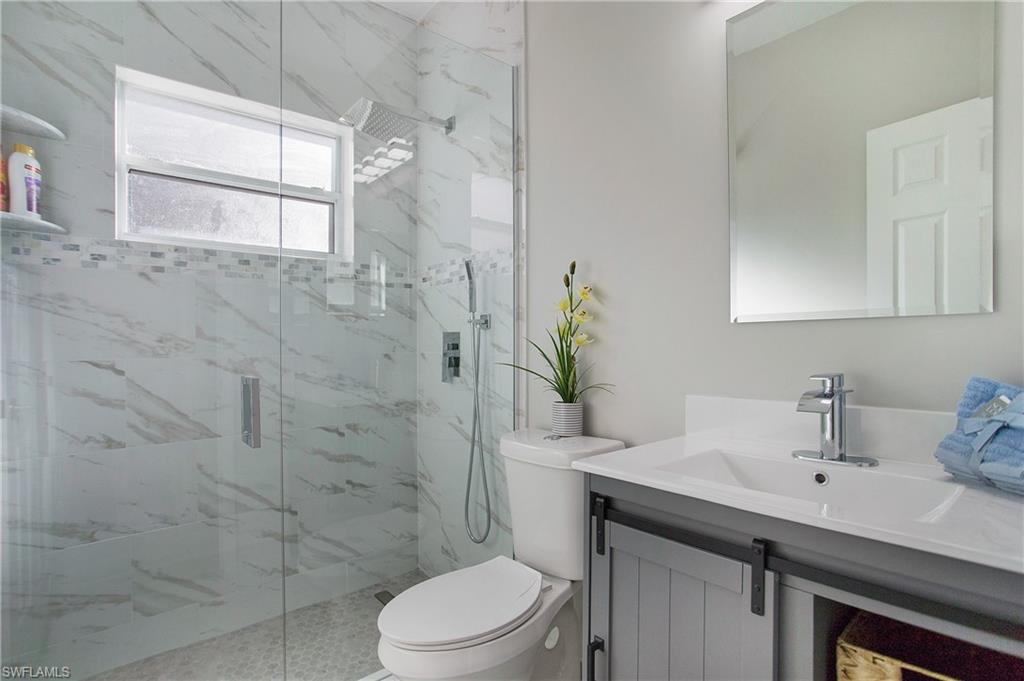 2921 Inlet Cove Lane East Naples, FL 34120 - Photo 27 of 48 a bathroom with a sink a toilet and shower