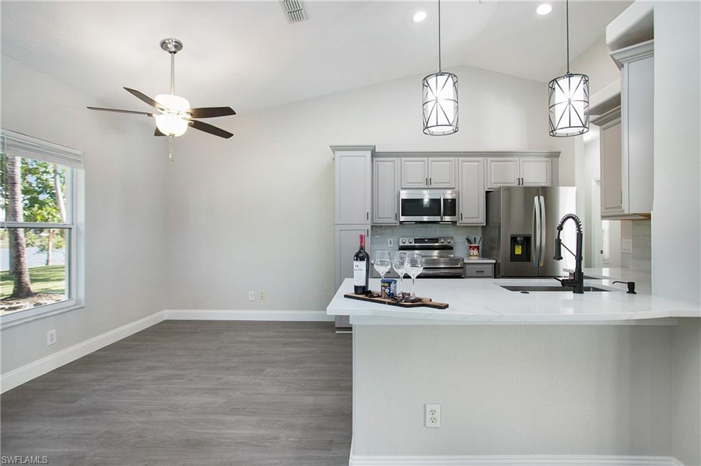 2921 Inlet Cove Lane East Naples, FL 34120 - Photo 3 of 48 a view of a room with chandelier fan and windows
