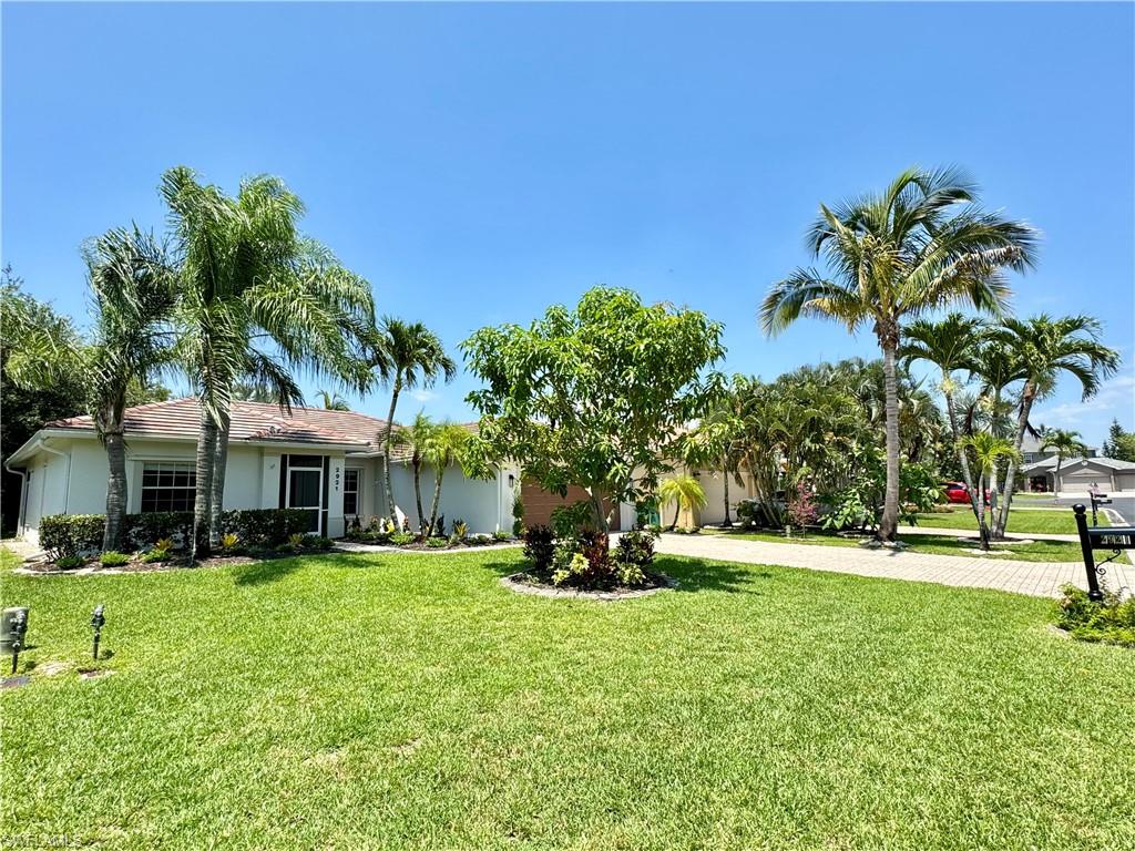 2921 Inlet Cove Lane East Naples, FL 34120 - Photo 32 of 48 a front view of a house with a yard