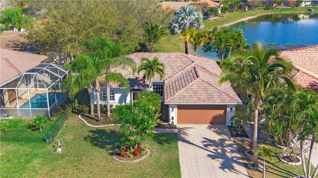 2921 Inlet Cove Lane East Naples, FL 34120 - Photo 33 of 48 an aerial view of a house with a garden and lake view