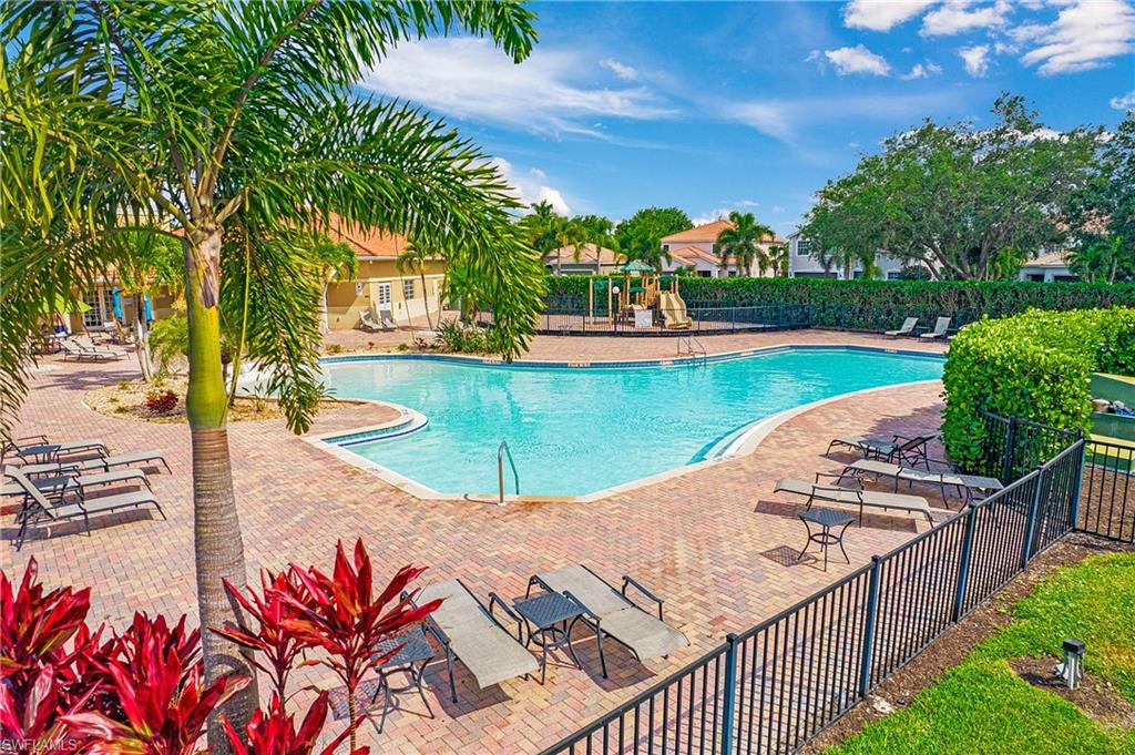 2921 Inlet Cove Lane East Naples, FL 34120 - Photo 48 of 48 a view of a swimming pool with a lounge chairs