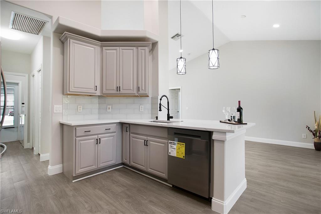 2921 Inlet Cove Lane East Naples, FL 34120 - Photo 6 of 48 a kitchen with a sink cabinets and wooden floor