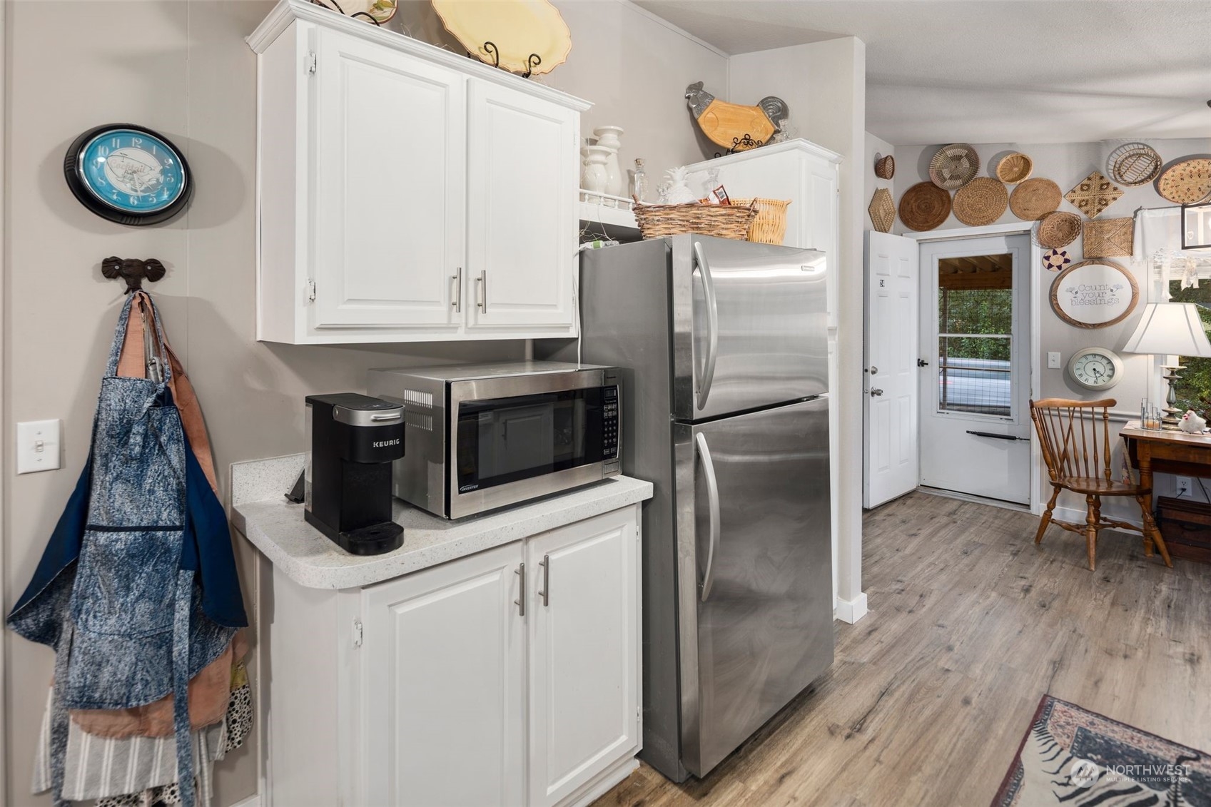8730 206th Street Southeast, Unit 24 Snohomish, WA 98296 - Photo 13 of 33 a kitchen with stainless steel appliances granite countertop a refrigerator a stove and a wooden floor
