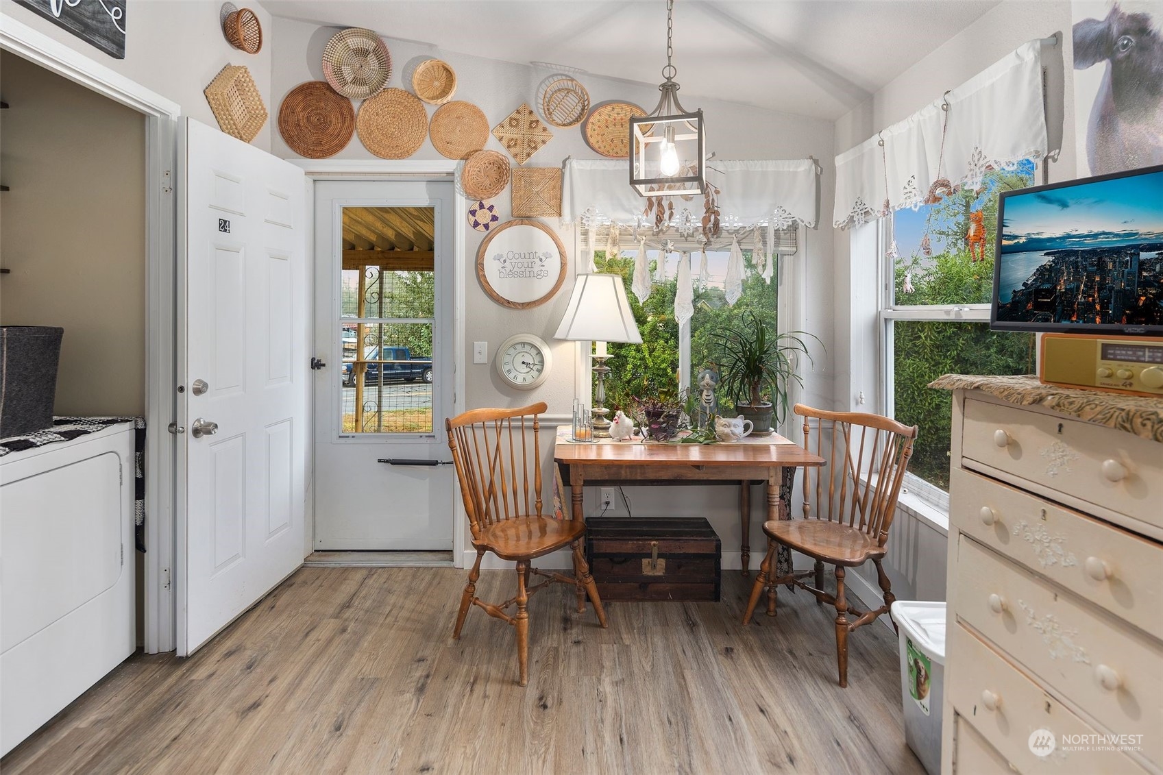 8730 206th Street Southeast, Unit 24 Snohomish, WA 98296 - Photo 14 of 33 a view of a dining room with furniture a kitchen and chandelier