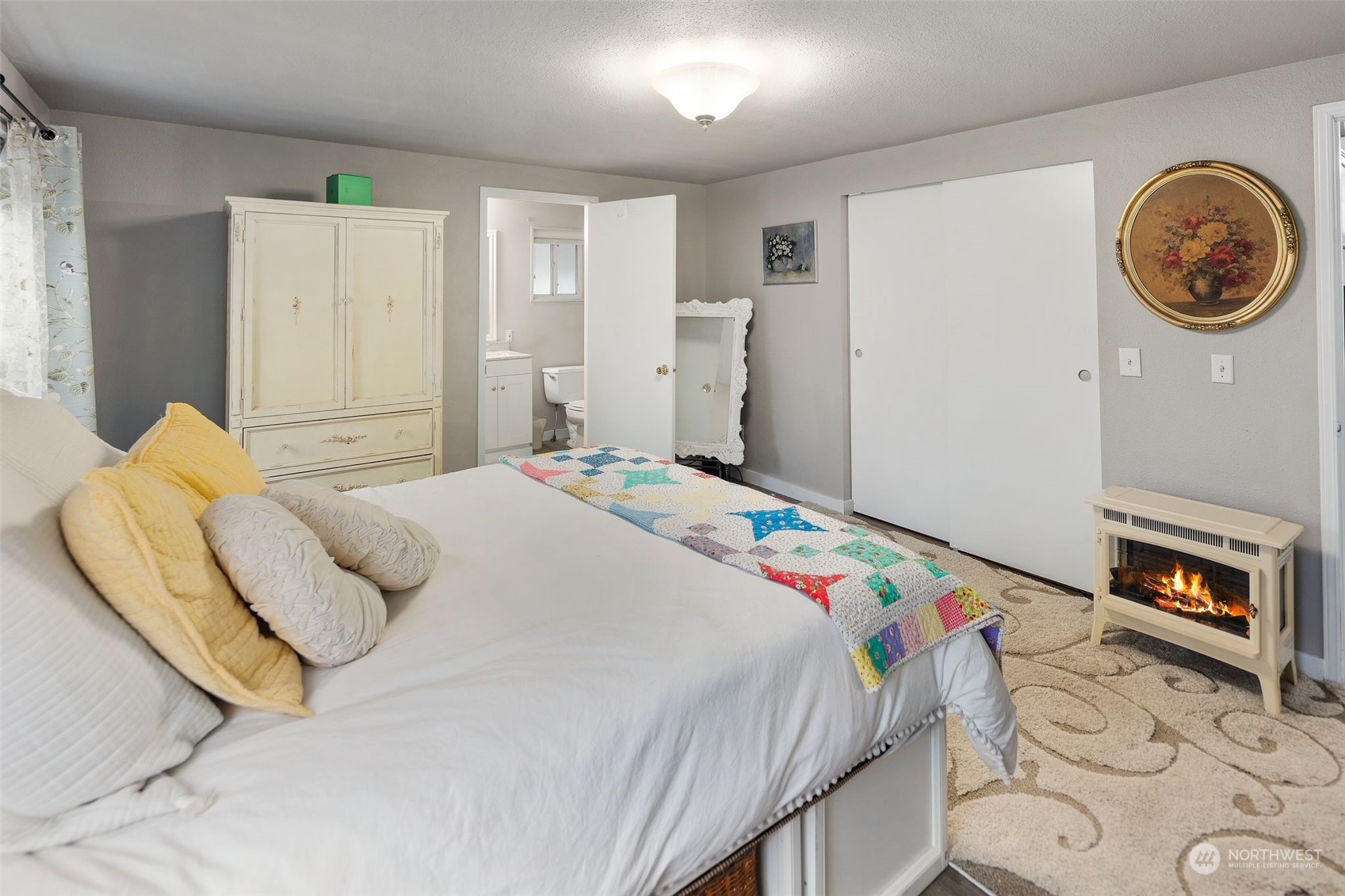 8730 206th Street Southeast, Unit 24 Snohomish, WA 98296 - Photo 19 of 33 a bedroom with a bed and a lamp on dresser