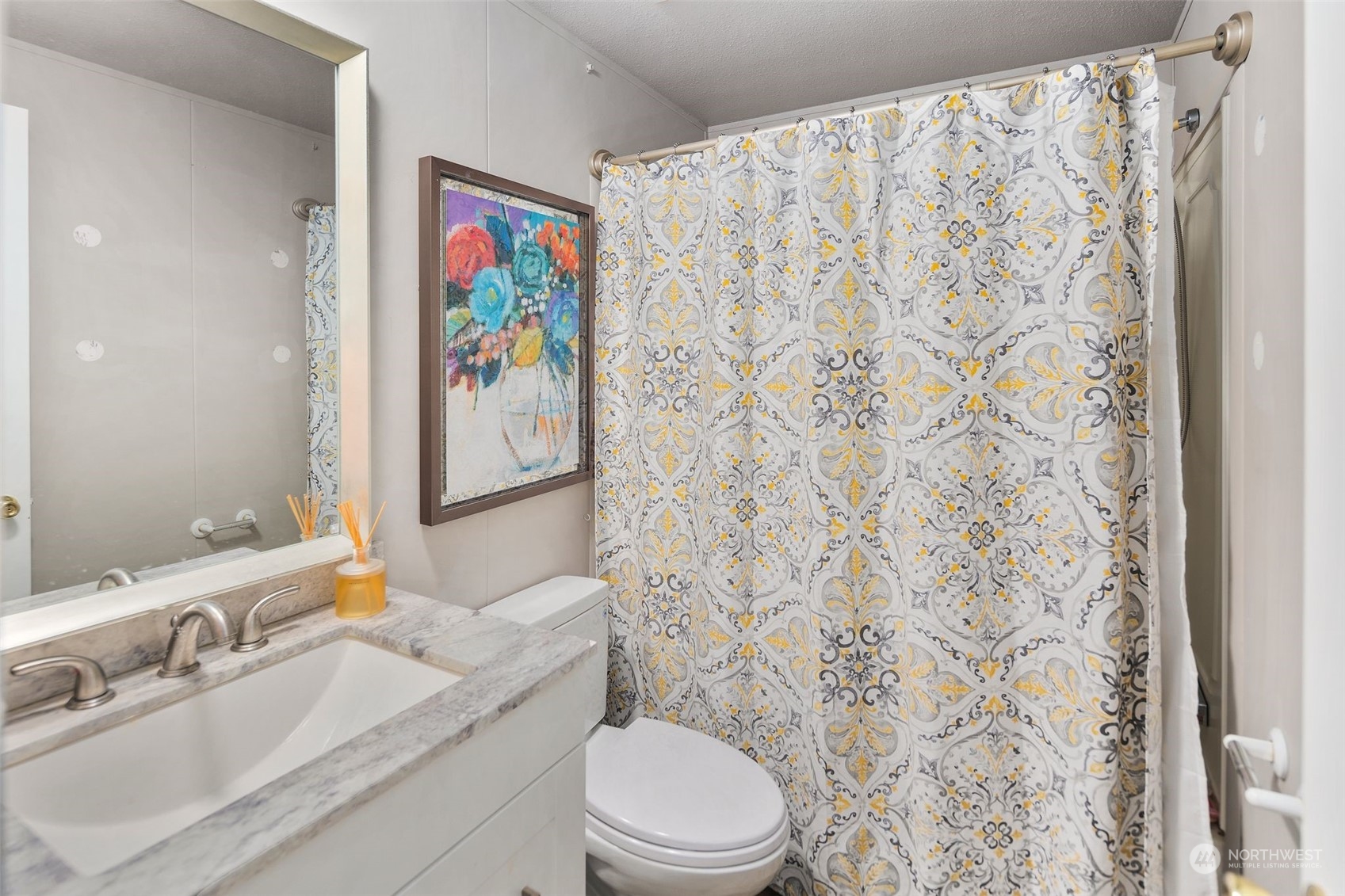 8730 206th Street Southeast, Unit 24 Snohomish, WA 98296 - Photo 24 of 33 a bathroom with a sink a toilet and a mirror