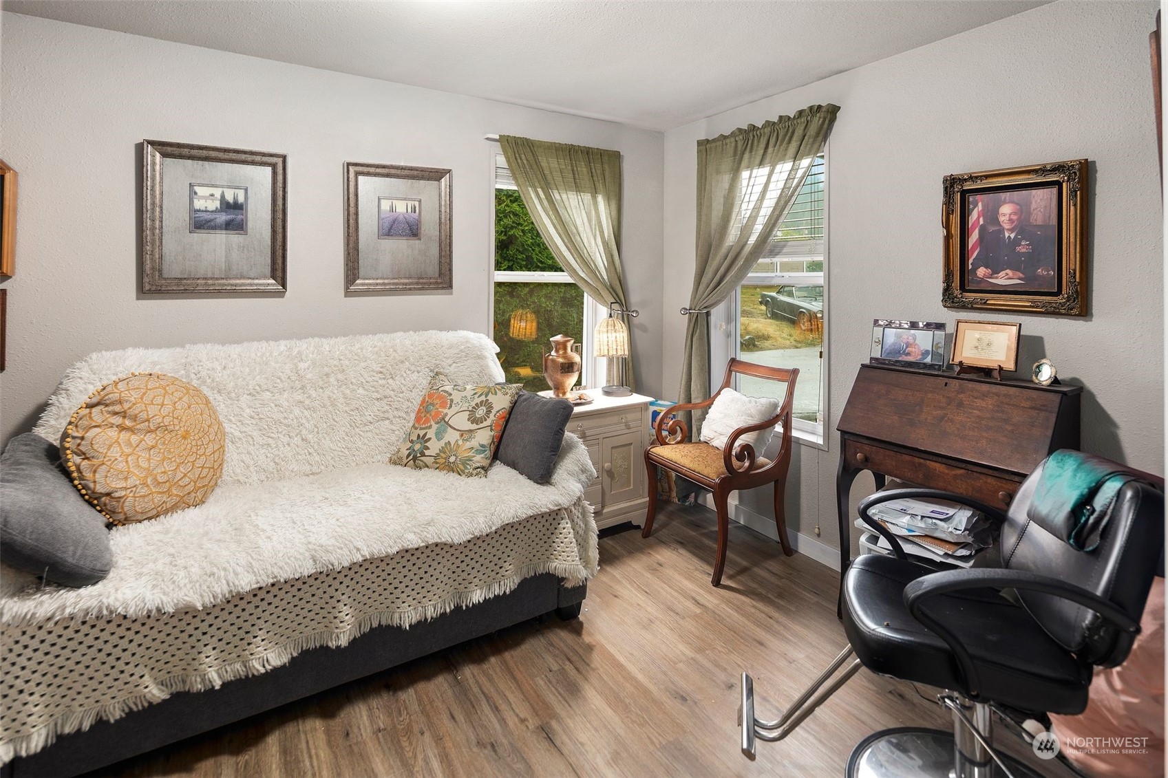 8730 206th Street Southeast, Unit 24 Snohomish, WA 98296 - Photo 25 of 33 a spacious bedroom with a bed a couch and large windows