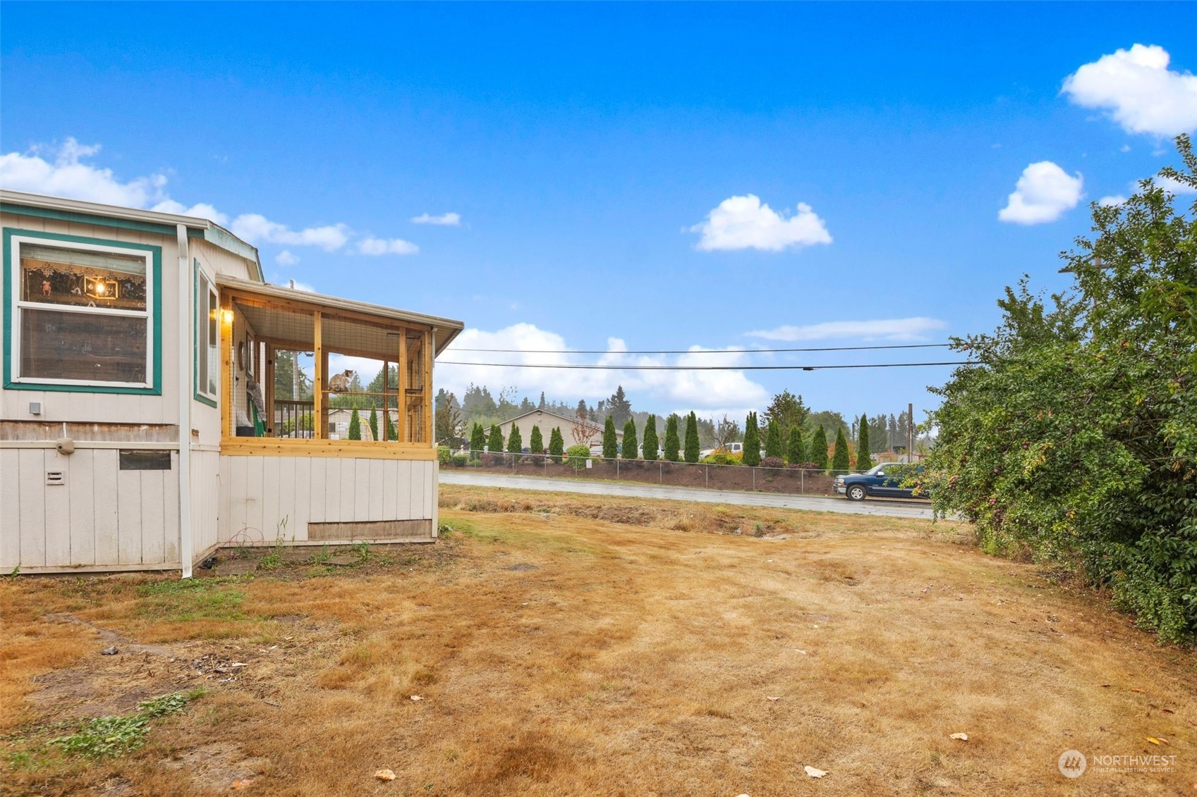8730 206th Street Southeast, Unit 24 Snohomish, WA 98296 - Photo 28 of 33 a view of a house with a yard and a large tree
