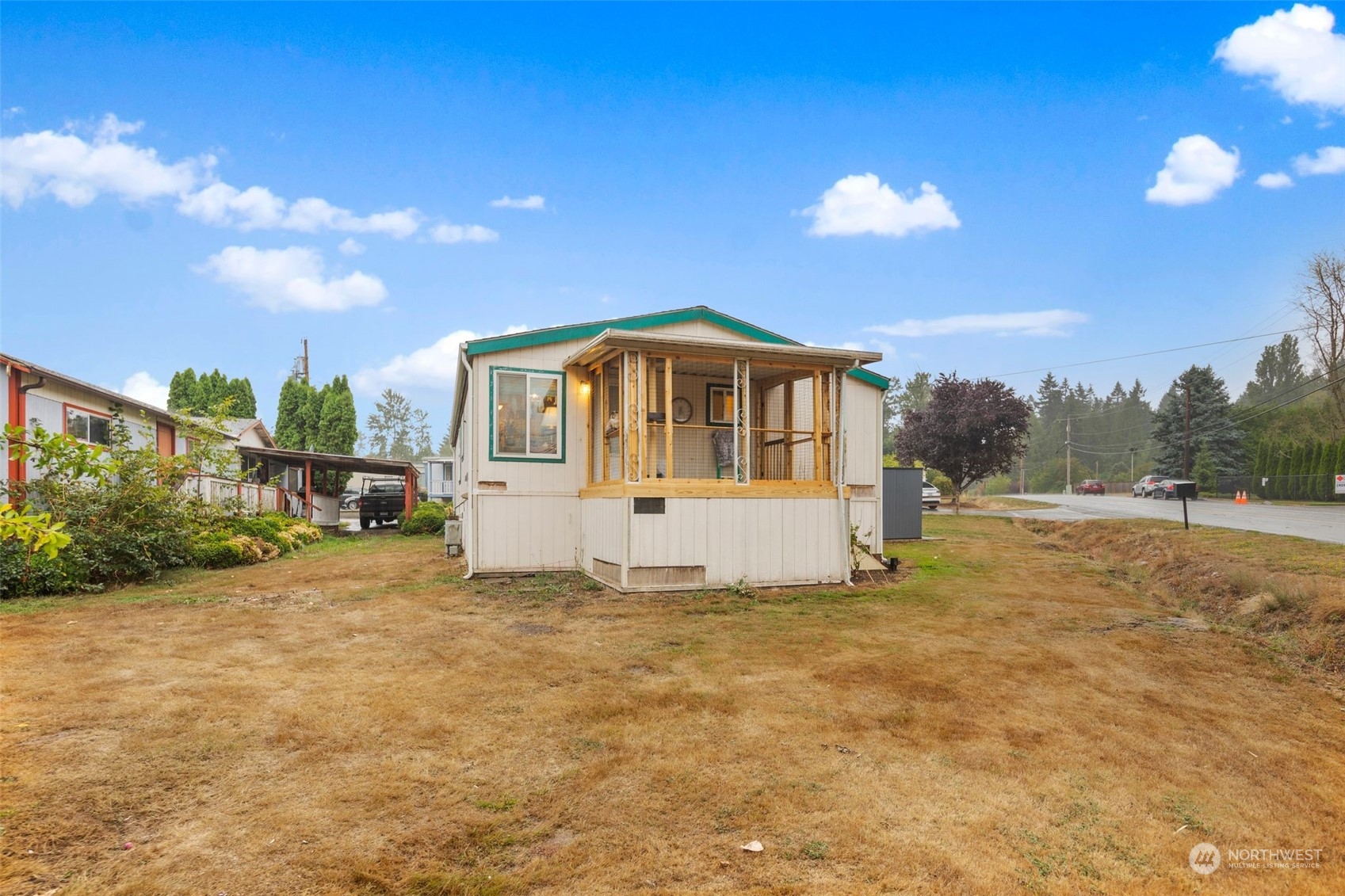 8730 206th Street Southeast, Unit 24 Snohomish, WA 98296 - Photo 29 of 33 a white house that has a big yard and large trees