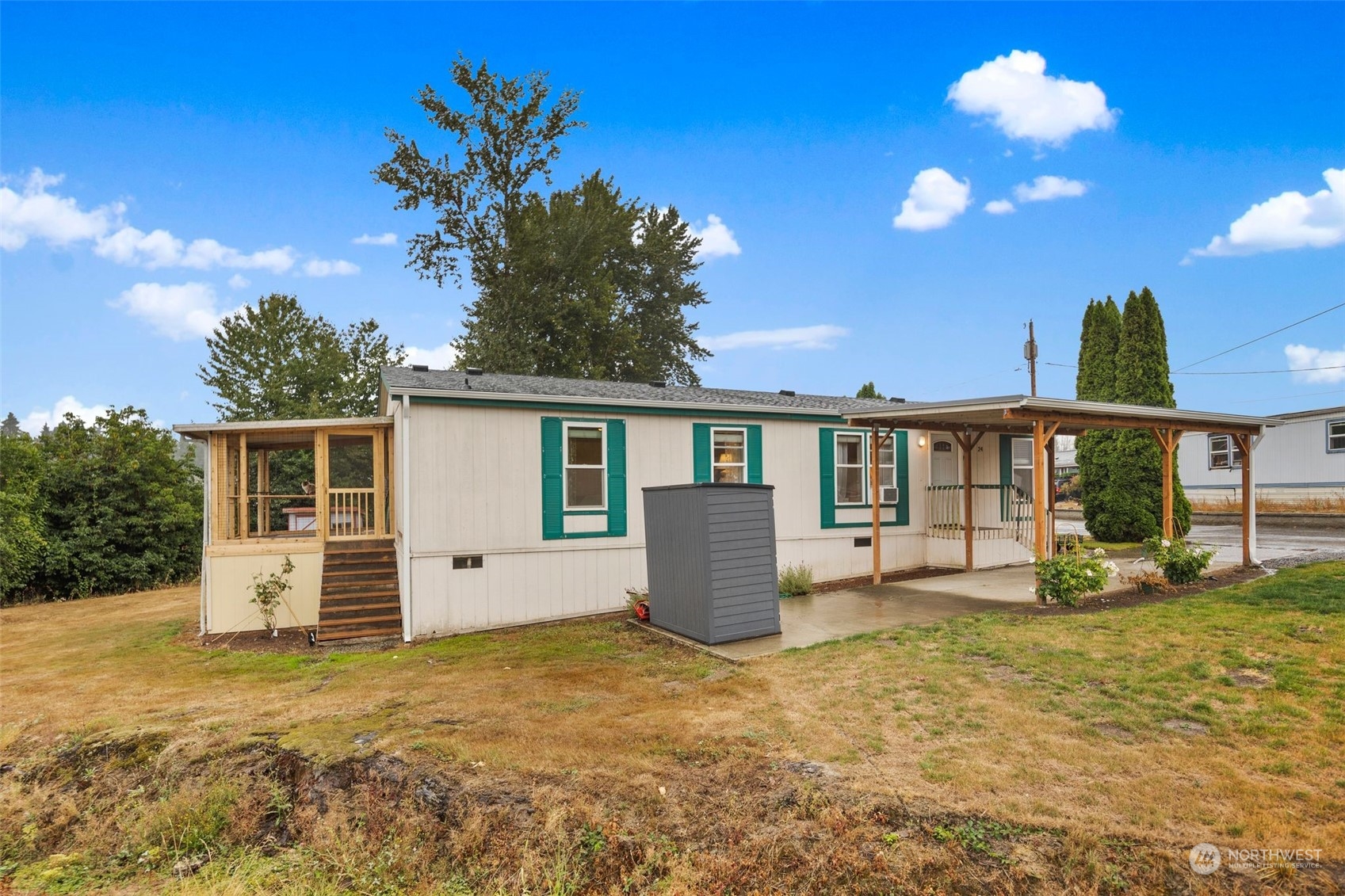 8730 206th Street Southeast, Unit 24 Snohomish, WA 98296 - Photo 30 of 33 a front view of a house with a yard